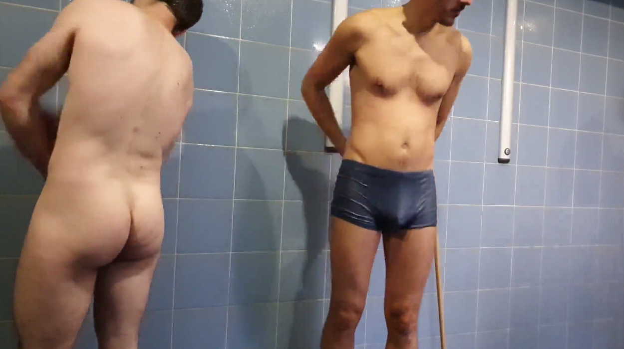 Nude-clothed guys wait their turn in the shower room! image